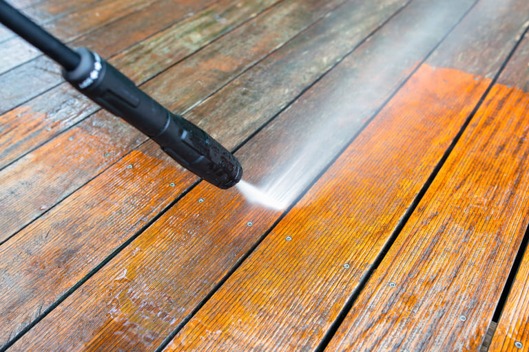 Professional deck cleaning service pressure washing wooden deck surface